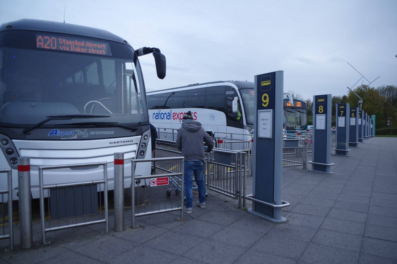A National Express coach at Stansted Airport coach station showing an A20 to London Baker Street destination sign